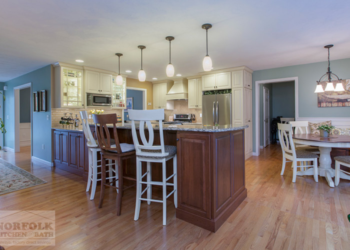 back side of peninsula showing cherry cabinets and tall bar stools.