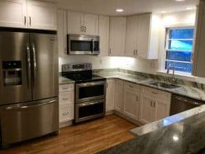 customer submitted image of white kitchen with hardwood floors