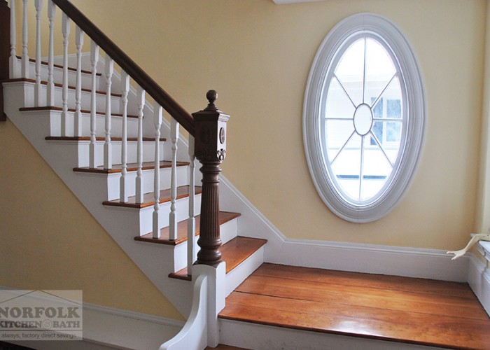 beautiful wood and paint stairway with large oval antique window