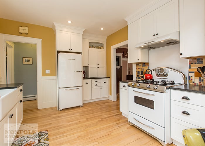 White kitchen with natural hardwood floors and retro white stove