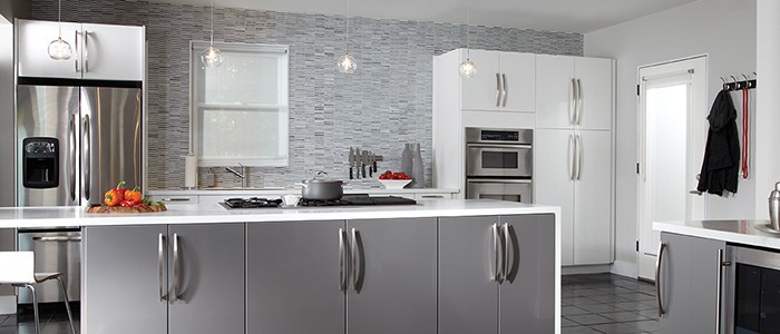 a kitchen with long modern silver cabinet hardware