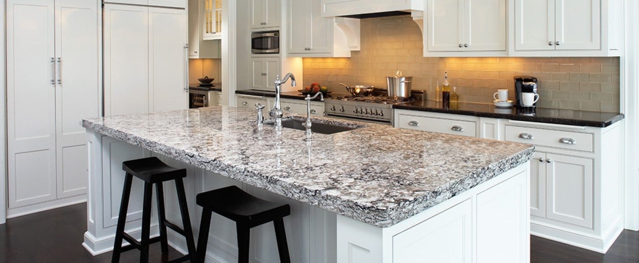 a white kitchen with a quartz kitchen countertop