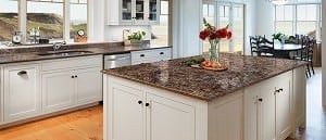 an off-white kitchen with a brown speckled quartz countertop