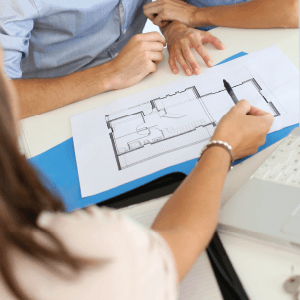 designer showing design on paper to couple