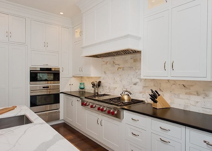 view of large cooktop and white wood hood over