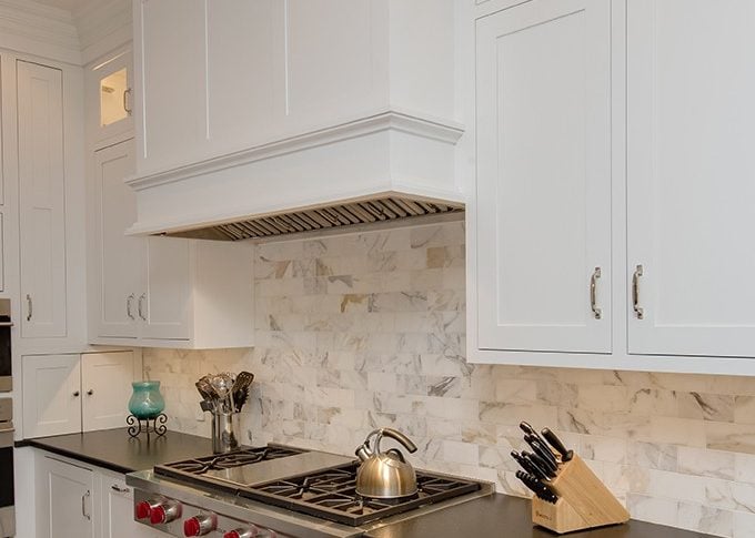 close up of wood hood and black granite countertop