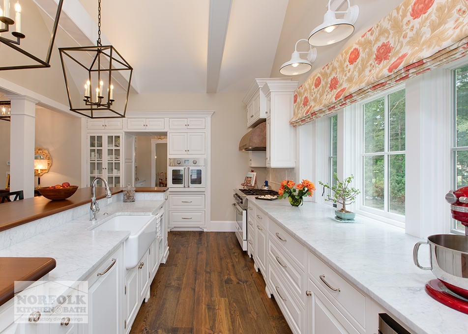 white kitchen with rich hardwood flooring