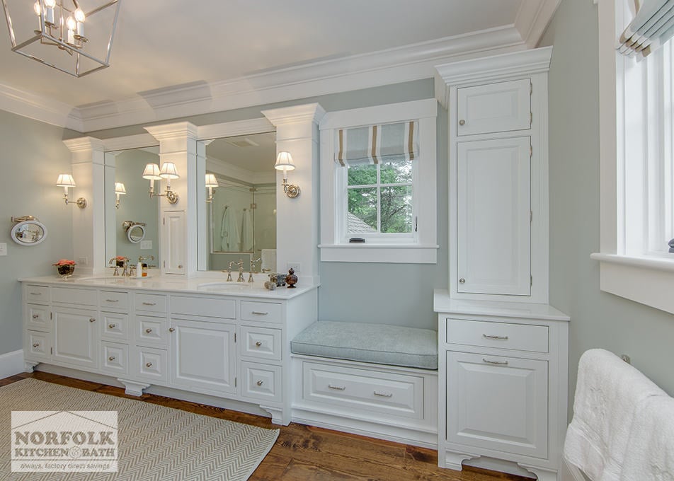 large master bath with white cabinets decorative moldings, seating area with green paint