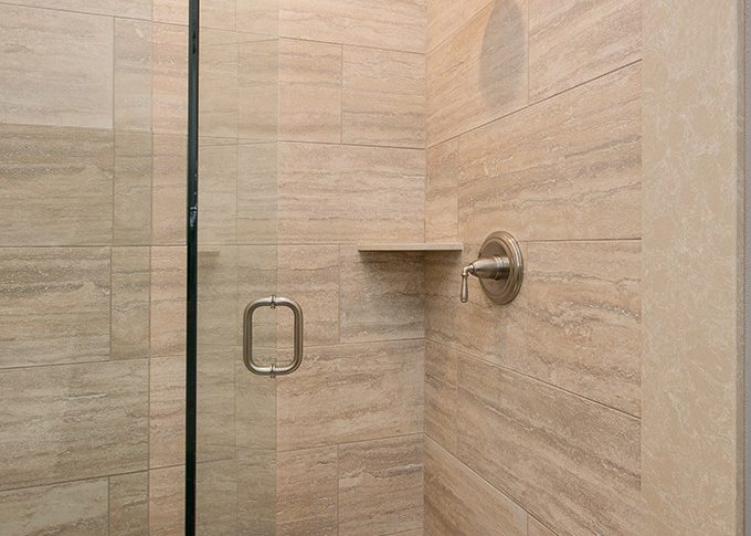 large marble tiles in shower with soap shampoo holder