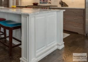 white kitchen island with decorative furniture posts