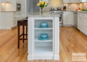 Kitchen island end with open shelves and fluted moldings