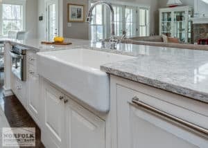 Kitchen island with farmers sink and microwave in base cabinet