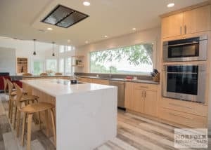 Light natural finish slab door Modern kitchen island with waterfall edge stone