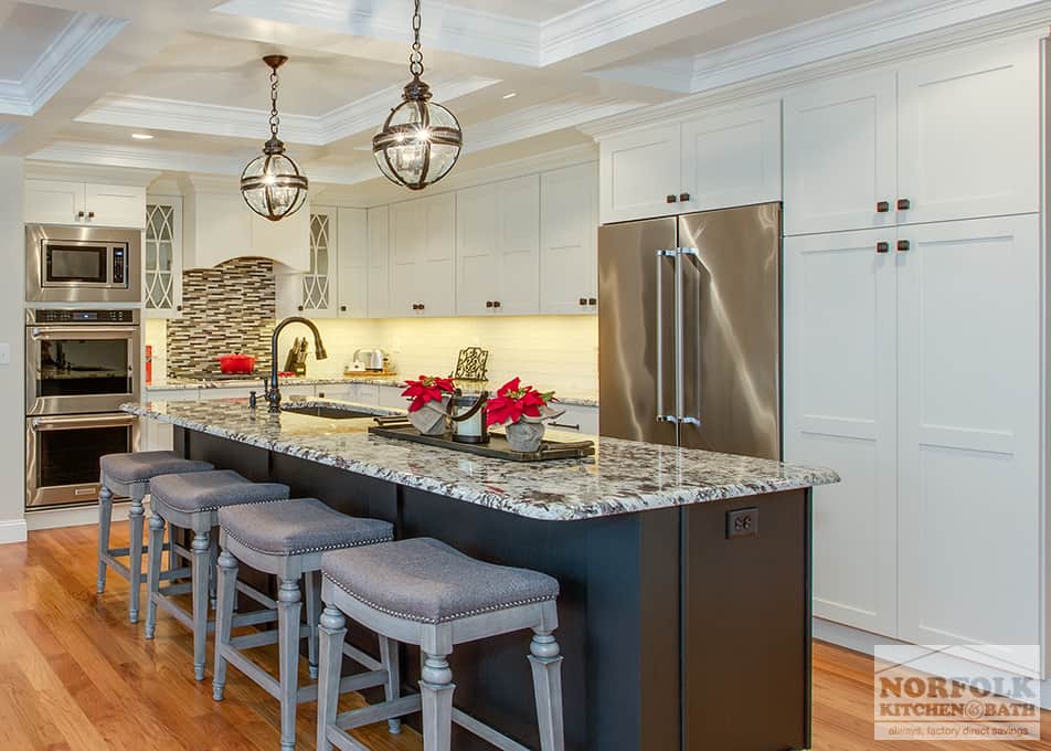 L-shaped white kitchen with a matte black kitchen island and granite countertops and pendant lighting