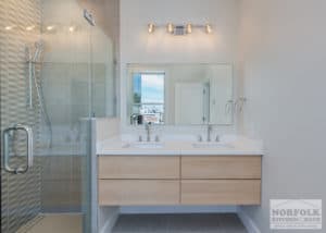 modern bathroom design with wall mount vanity with light maple slab doors