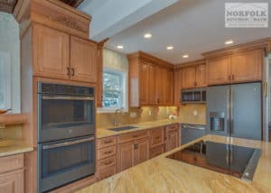 Maple Kitchen with yellow toned granite tops and large wall oven