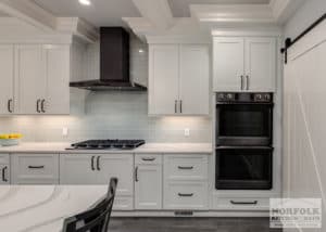 white kitchen cabinets with quartz countertops and black stainless steel appliances. Black stainless is an up and coming kitchen trend