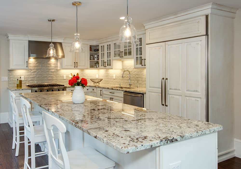 White kitchen with island and stainless appliances