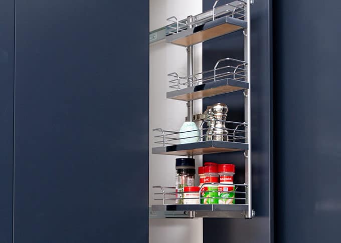 close up of a modern blue cabinet with a white interior and a specialty spice rack add-on