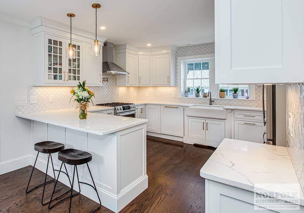 beautiful white kitchen with wood floors in customer home