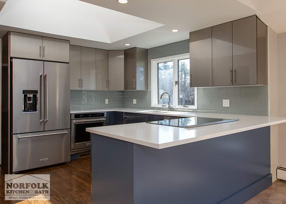 close up of a gray and blue high-gloss kitchen with peninsula and stainless steel appliances