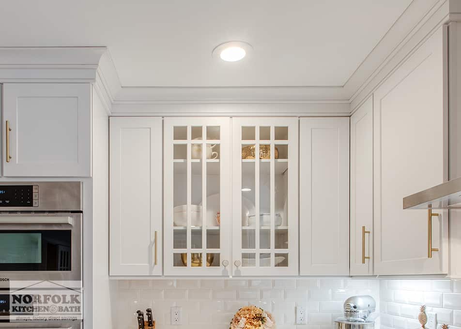 close up of a white kitchen cabinet with mullion glass doors