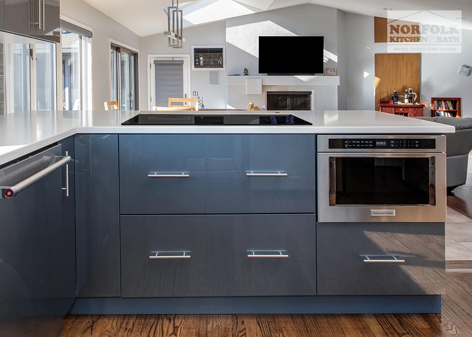 high gloss blue base cabinets on a kitchen peninsula that face the great room area