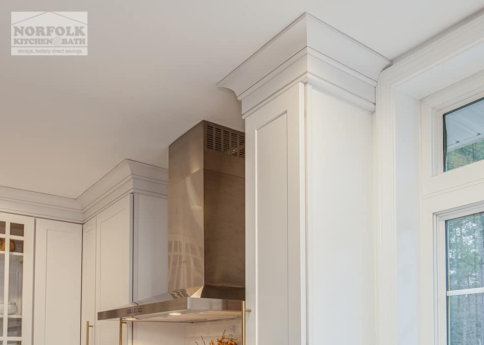 close up of crown molding on white kitchen cabinets