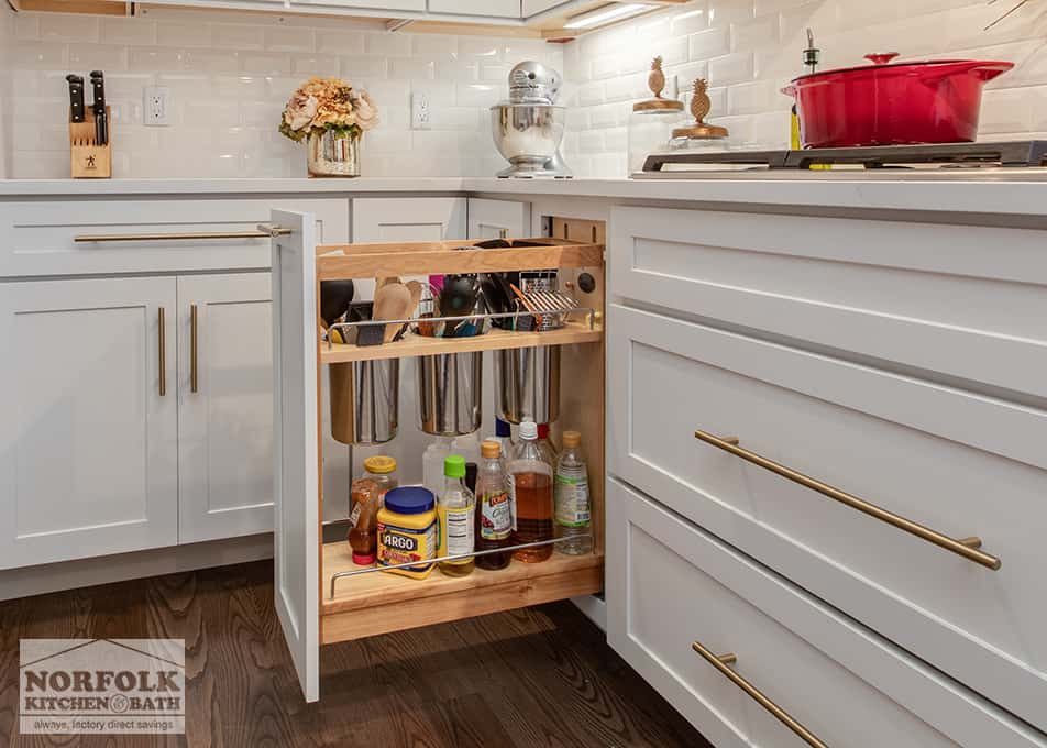 white kitchen cabinet with pull out utensil storage