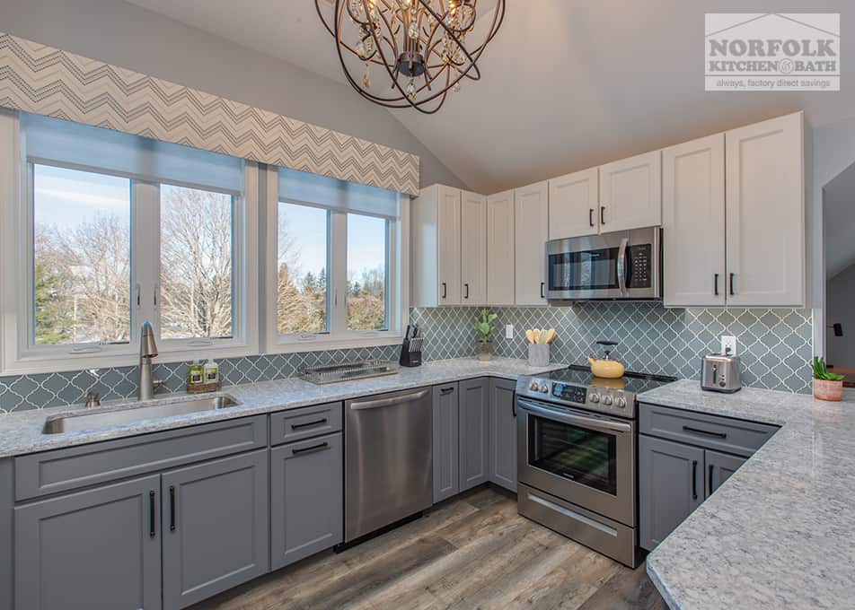 a kitchen remodel in Hampton Falls, NH featuring white and grey kitchen cabinets and stainless steel appliances