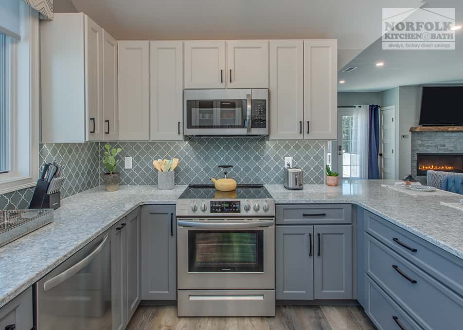 a kitchen remodel in Hampton Falls, NH featuring white and grey kitchen cabinets and stainless steel appliances