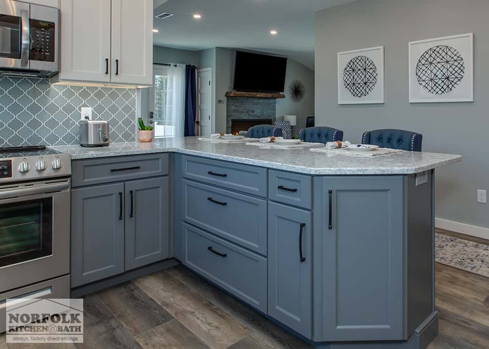 close up of the large peninsula with gray cabinetry and a quartz kitchen countertop