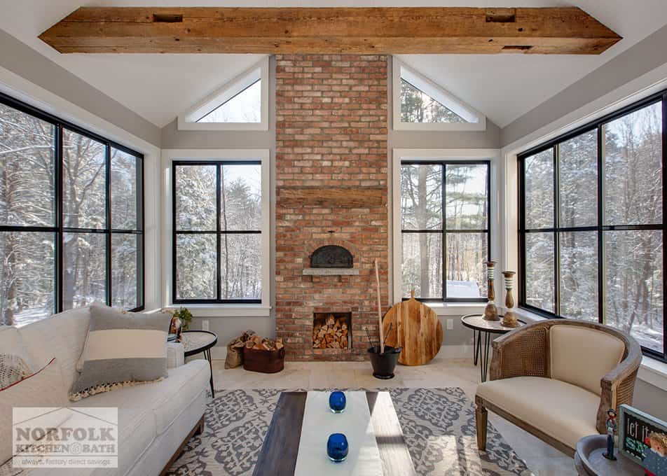 a beautiful sunroom with a large brick pizza oven in the center