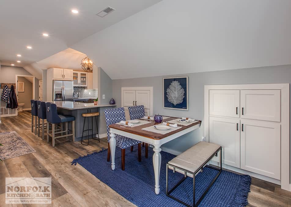 dining area with white built ins around it and the kitchen in the background