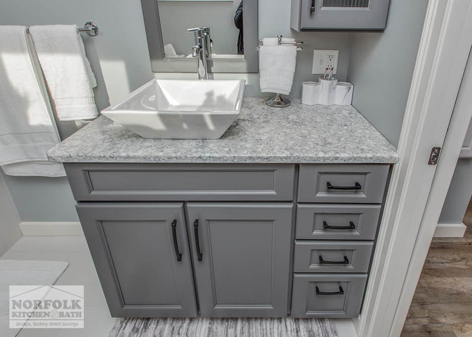 top down view of a dark grey single bath vanity with a white square vessel sink and a quartz countertop
