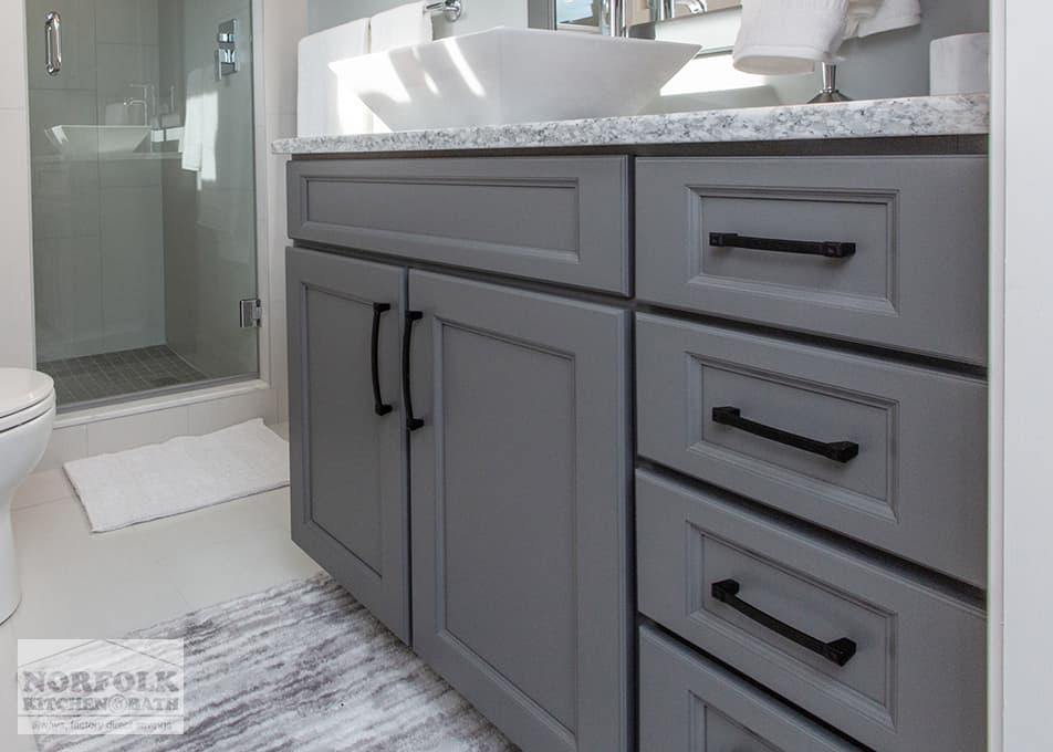side view of a dark gray bathroom single vanity with modern black hardware