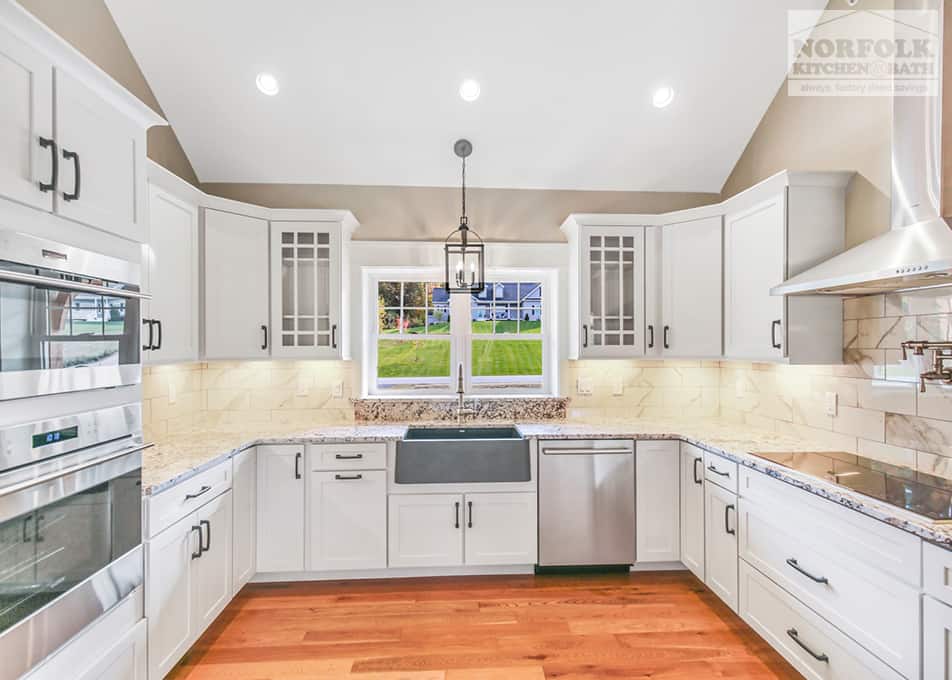 white kitchen with granite countertops and stainless steel kitchen appliances in a new home in Gilford, NH