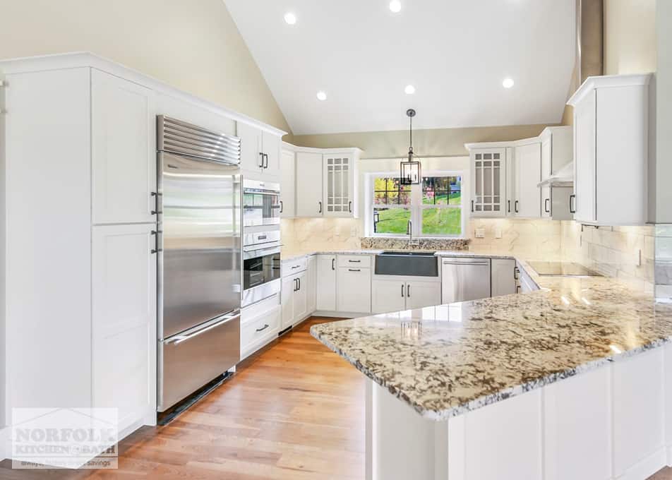 white kitchen with granite countertops and stainless steel kitchen appliances in a new home in Gilford, NH