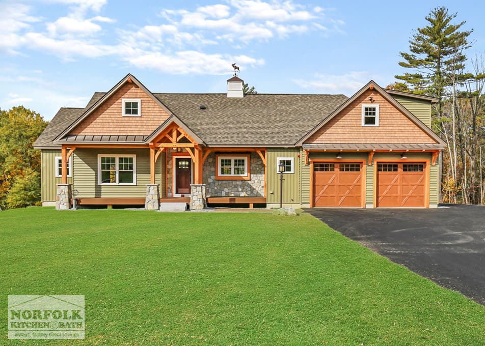 front exterior of a new construction home with green grass and a blue sky with clouds