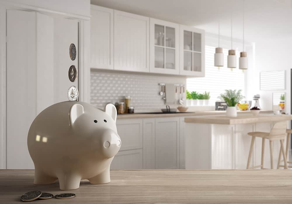 a white ceramic piggybank with a white kitchen in the background