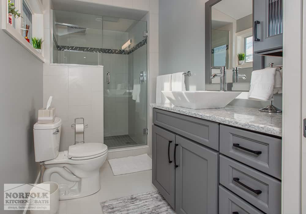 dark grey bath vanity with black pulls in bathroom