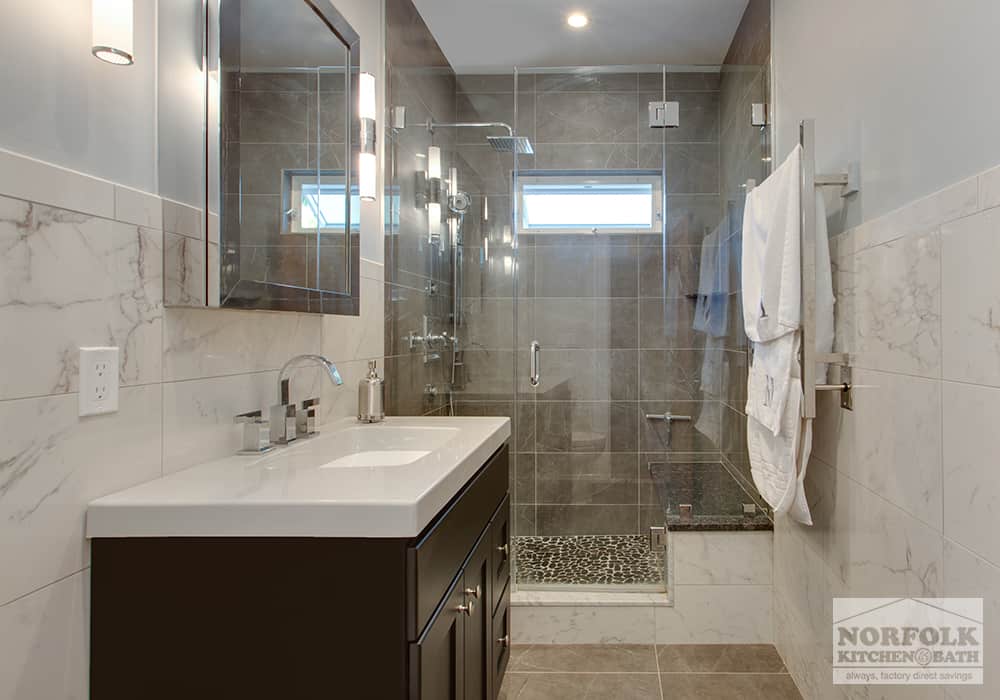 glass door shower and vanity fully tiled bath