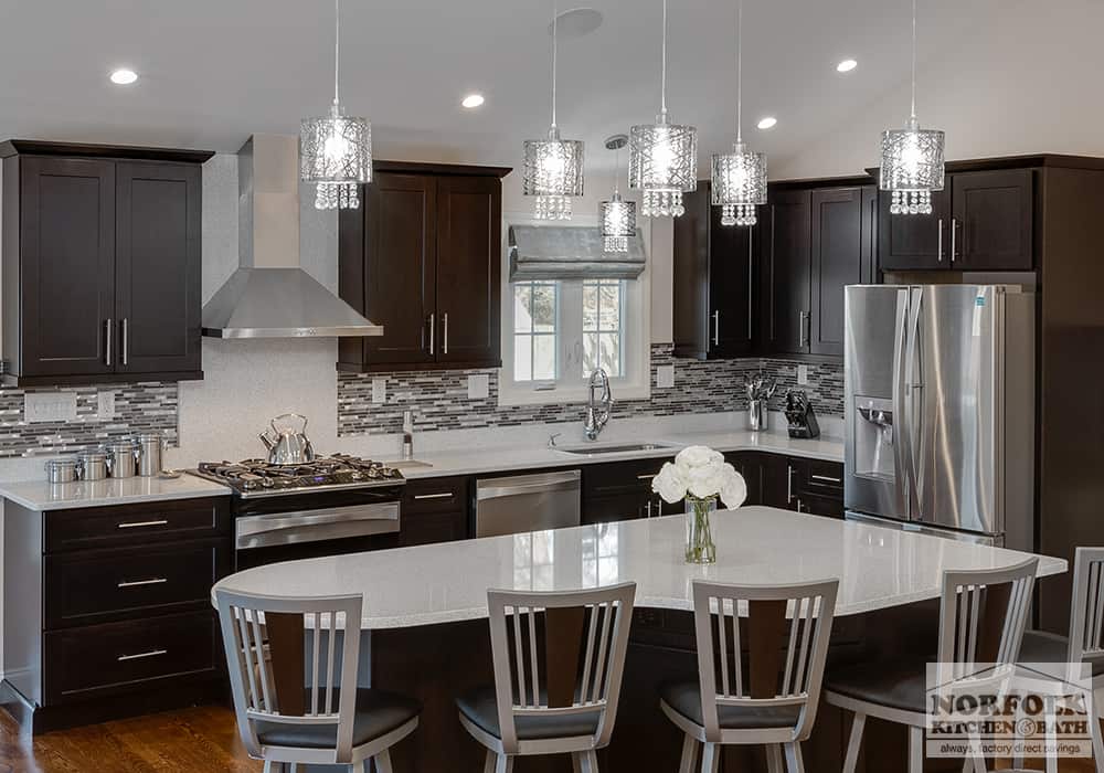 modern kitchen with dark wood and shaker doors with white countertops