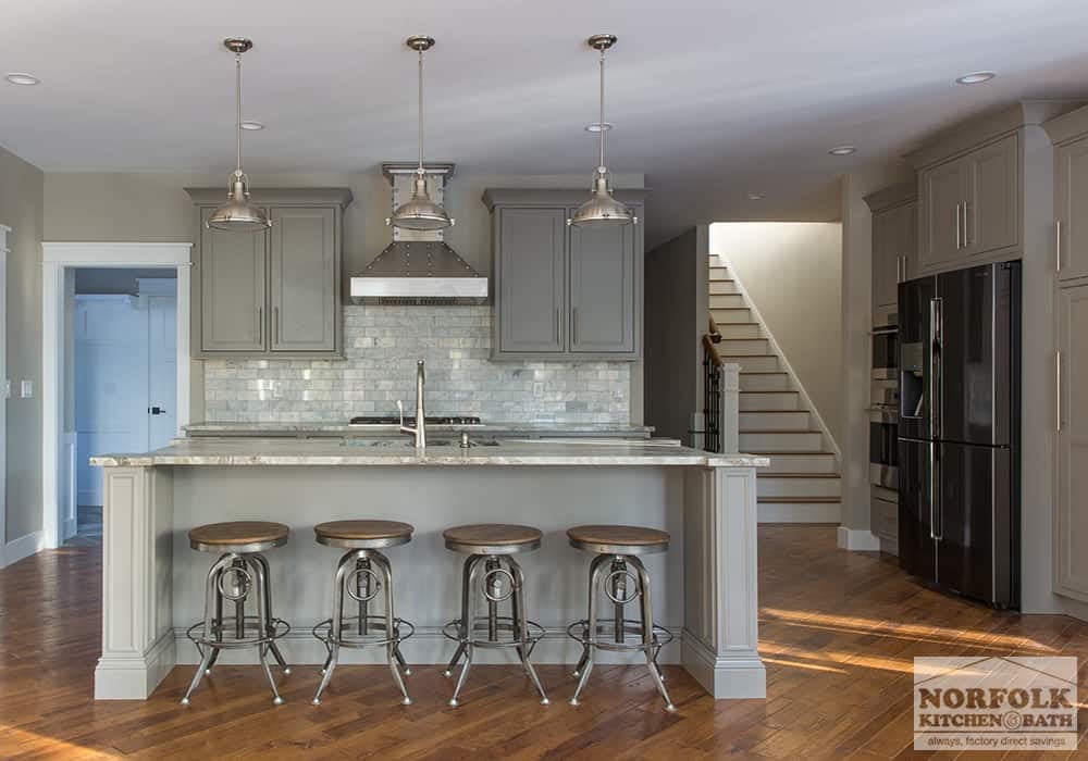 grey kitchen with granite, island and industrial accent pieces