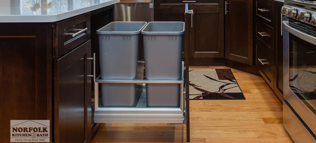 a dark brown kitchen with a double trash pull out cabinet upgrade