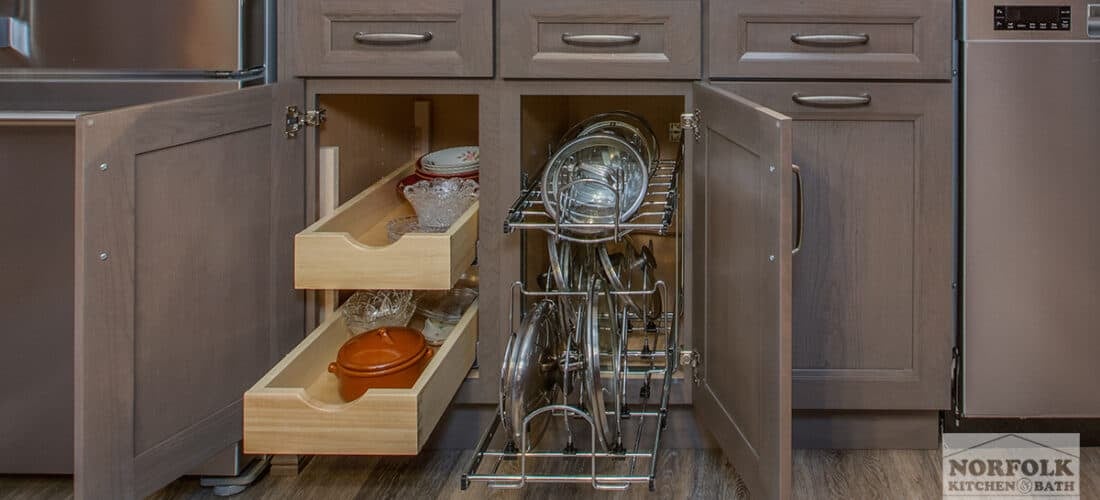 medium-stained kitchen cabinets with pull-out drawers and a pot lid organizer