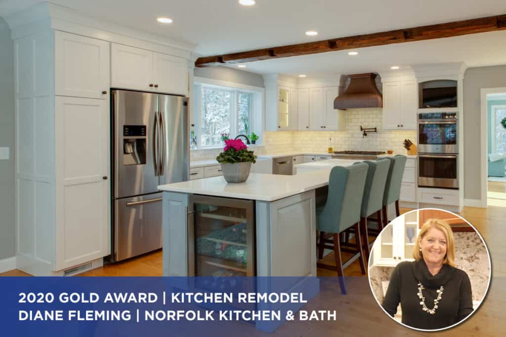 A white kitchen remodel with a gray island and a copper range hood designed by Diane Fleming, a 2020 Cornerstone Award winner