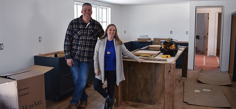Kristina Crestin and the general contractor on the set of HGTV's Farmhouse Fixer