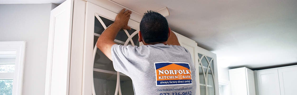 Norfolk Kitchen remodeler installing crown molding on kitchen cabinets