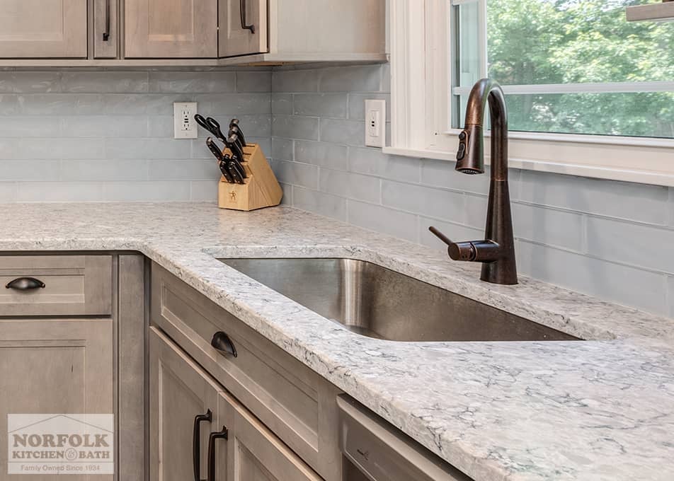 close up of white stone countertops and a kitchen sink in a Wilmington, MA kitchen remodel